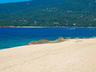 Empty sandy beach with mountain in background, Corsica, France