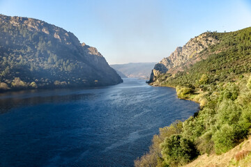 Tejo River crossing rocky cliffs of two mountains, Portas do Rodao, and vast vegetation, town Vila Velha de Ródão, Castelo Branco district, Centro region, Portugal