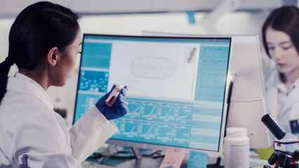 Modern laboratory. Female scientists team working on water flea daphnia samples