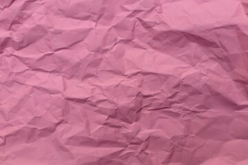 Fototapeta premium Pink crumpled paper textured background.