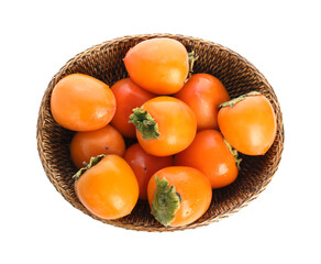 Wicker bowl with delicious persimmons isolated on white, top view