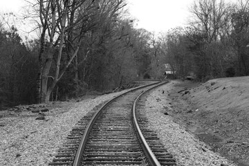 a single spooky train tracks leading into the distance in black and white