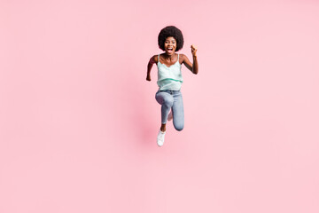 Full length photo of astonished lady open mouth fists up jumping wear blue tank-top isolated on pink color background