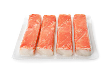 Delicious crab sticks in plastic packaging isolated on white