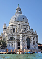 Obraz premium The Basilica di Santa Maria della Salute adorns the Grand Canal of Venice. A noble and landmark structure with beautiful interior and statues of the Apostles.