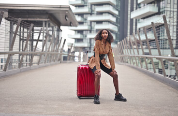 young woman with trolley in a station