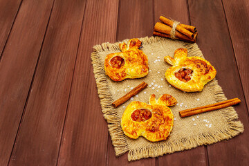 Homemade apple dessert, portioned puffs with fragrant cinnamon sticks