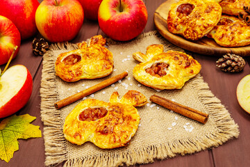 Homemade apple dessert, portioned puffs with fragrant cinnamon sticks, colorful foliage, autumn good mood