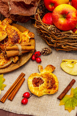 Homemade apple dessert, portioned puffs with fragrant cinnamon sticks, colorful foliage, autumn good mood