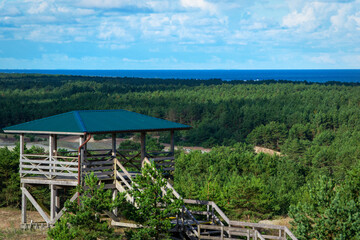 Fototapeta na wymiar observation deck in a coniferous forest on the dunes of the Curonian Spit, side view