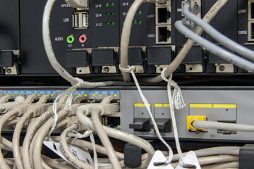 Fiber optic cables connected to the data center. Indicators are on, data transfer is in progress. Computer equipment. Selective focus.