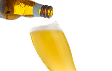 Pouring beer into glass on isolated background