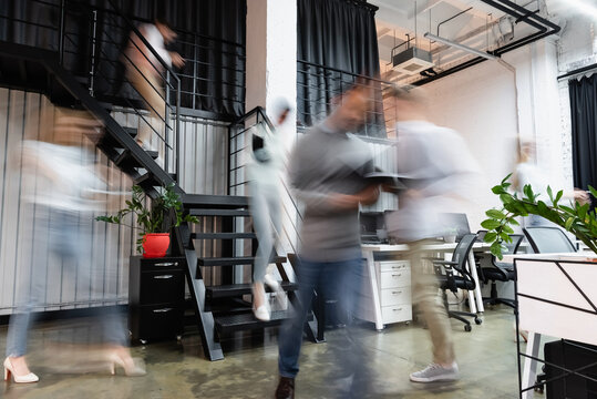 Motion Blur Of Businesspeople Working In Office