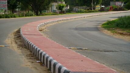 Pink color road divider in a countryside road in India