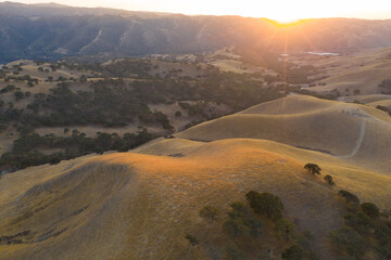 The last light of day shines on the rolling hills in Northern California. These beautiful, golden hills turn green once winter brings seasonal rain to the region.