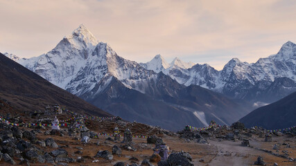Memorial for the dead mountaineers near Lobuche, Himalayas, Nepal with stone monuments, colorful...