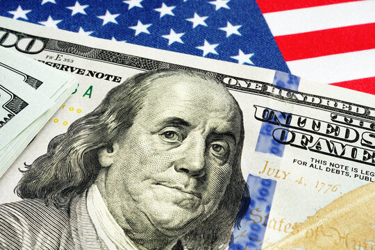 USA flag and dollar bills as symbol of stimulus check of cares act.