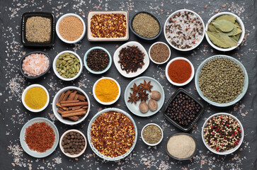Obraz na płótnie Canvas Assortment of aromatic spices and herbs in small bowls 