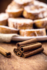 cinnamon stick on rustic table with sweet toast in the background