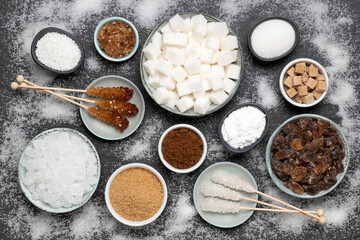 Different kinds of sugar in bowls, top view
