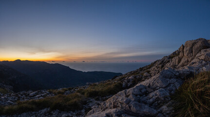 Naklejka na ściany i meble Panoramic of mountains and sea in the background at sunset with blue hour, sierra de tramuntana mallorca