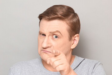 Obraz premium Portrait of serious blond mature man pointing with finger at you
