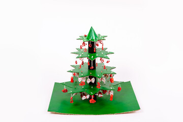 Step by step instruction how to make Christmas tree. Using glue we connect the star tiers decorated with pasta to each other with pieces of tube from paper towels and glue on a cardboard stand
