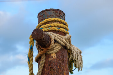 rusty mast with ties and knots