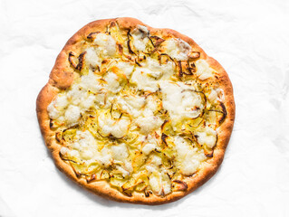 Potatoes, onions, mozzarella focaccia on a light background, top view. Vegetarian pizza with potatoes, onions and mozzarella