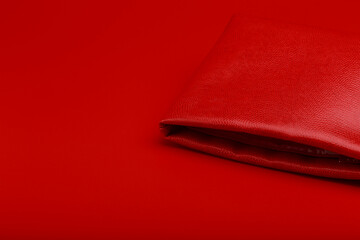 Red purse on a red background still life