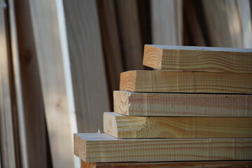 Wooden braces to build a roof. Materials for sale within a sawmill. Wood industry. Production factory.