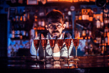 Focused mixologist demonstrates the process of making a cocktail in cocktail bars