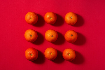Fresh tangerines pattern on red background	