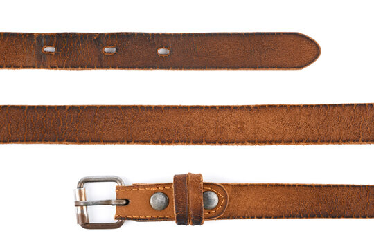 Old leather men's belt on a white background. Brown belt for men. Brown leather belt for trousers and jeans. Male accessory. Vintage things. 