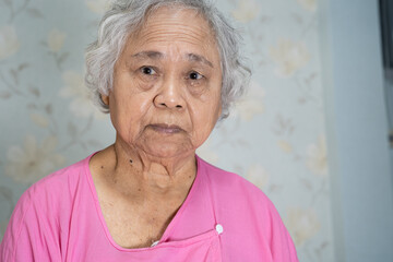 Asian senior or elderly old lady woman patient smile bright face while sitting on bed in nursing hospital ward, healthy strong medical concept.