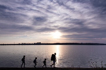 Naklejka na ściany i meble Father with children hiking together along sea beach