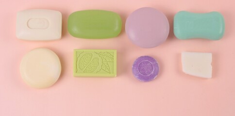 Hygiene and prevention of viral diseases concept. Various soap bar on a pink background. Top view with copy space.Banner