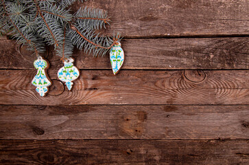 Greeting card with decor homemade gingerbread cookies, Christmas and New Year ornament  on old wooden background. Overhead of Christmas New Year holiday background. Top view. Copy space