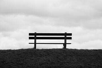 Park bench view on the clouds Doel black and white