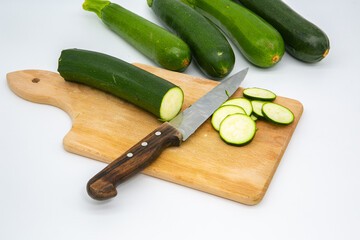 Cutting zucchini on a wooden cutting board