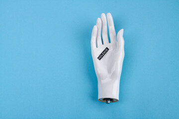 White dummy hand with violence word. Isolated on blue background.