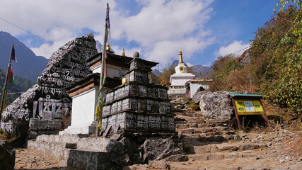 Buddhist religious monuments and mani stones besides a footpath on Everest Base Camp Trek, Khumbu,...
