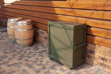 a drawer and oak barrels stand near the restaurant under a canopy