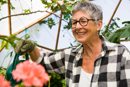 senior woman gardening in geodesic gome