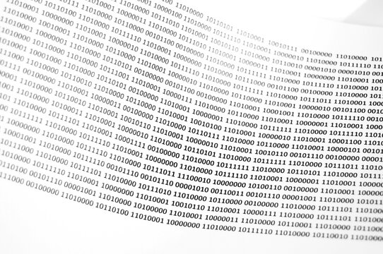 Binary code printed in black on a white sheet of paper, binary code background and texture.