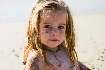 portrait of 3 year old girl at the beach