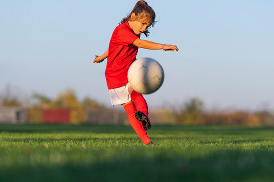 Little Girl Kicks Soccer Ball