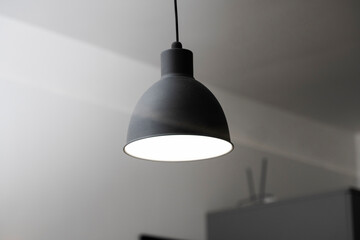 Industrial black look pendant lamps in a kitchen interior. Modern loft interior design.