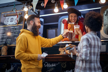friends having a toast with a employee in fast food service