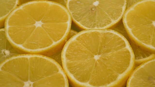 Juicy Fresh Slices of Lemon Cirtus Rotate, Close-up, Macro, Top View. The Concept of a Healthy Vegan Diet and a Vitamin-Rich Vegetarian Diet.